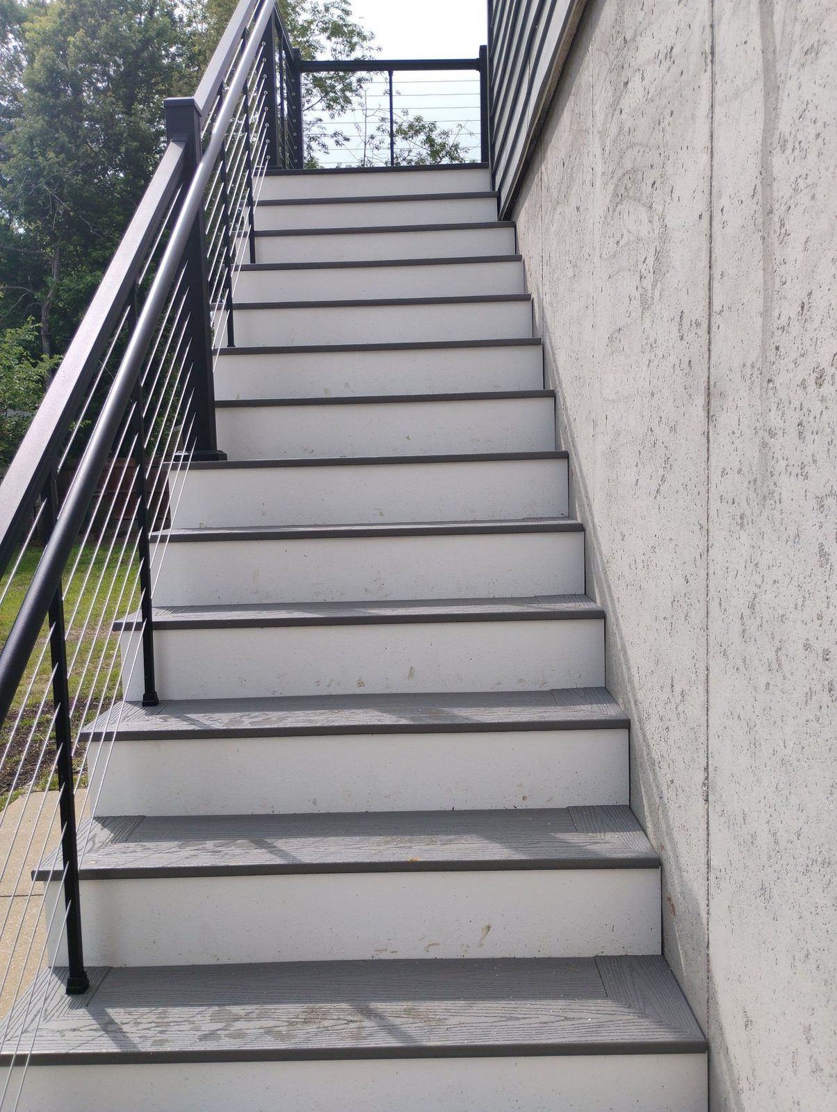 Black metal railings on completed exterior stairs