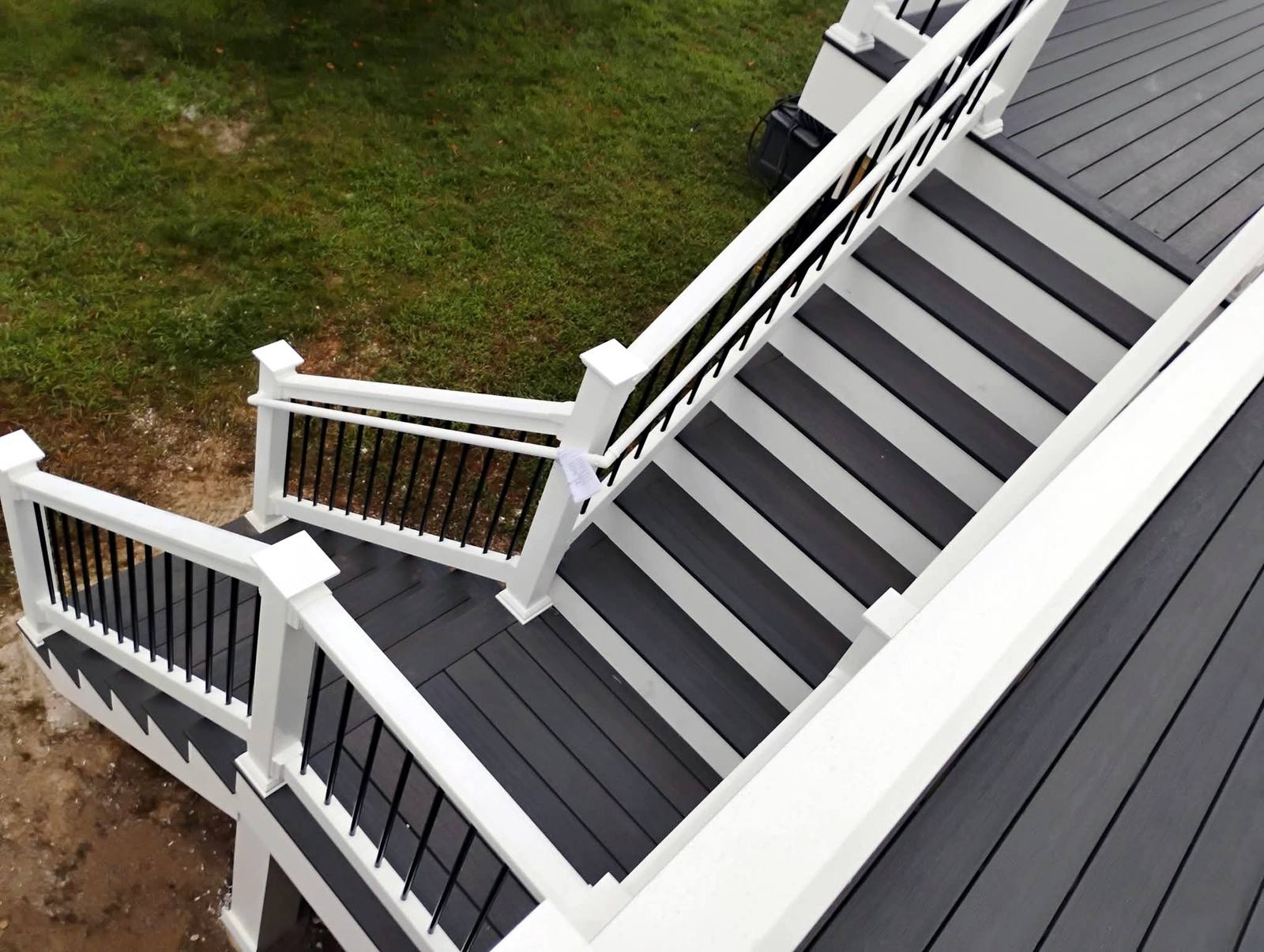 Finished composite deck stairs with white and black railings
