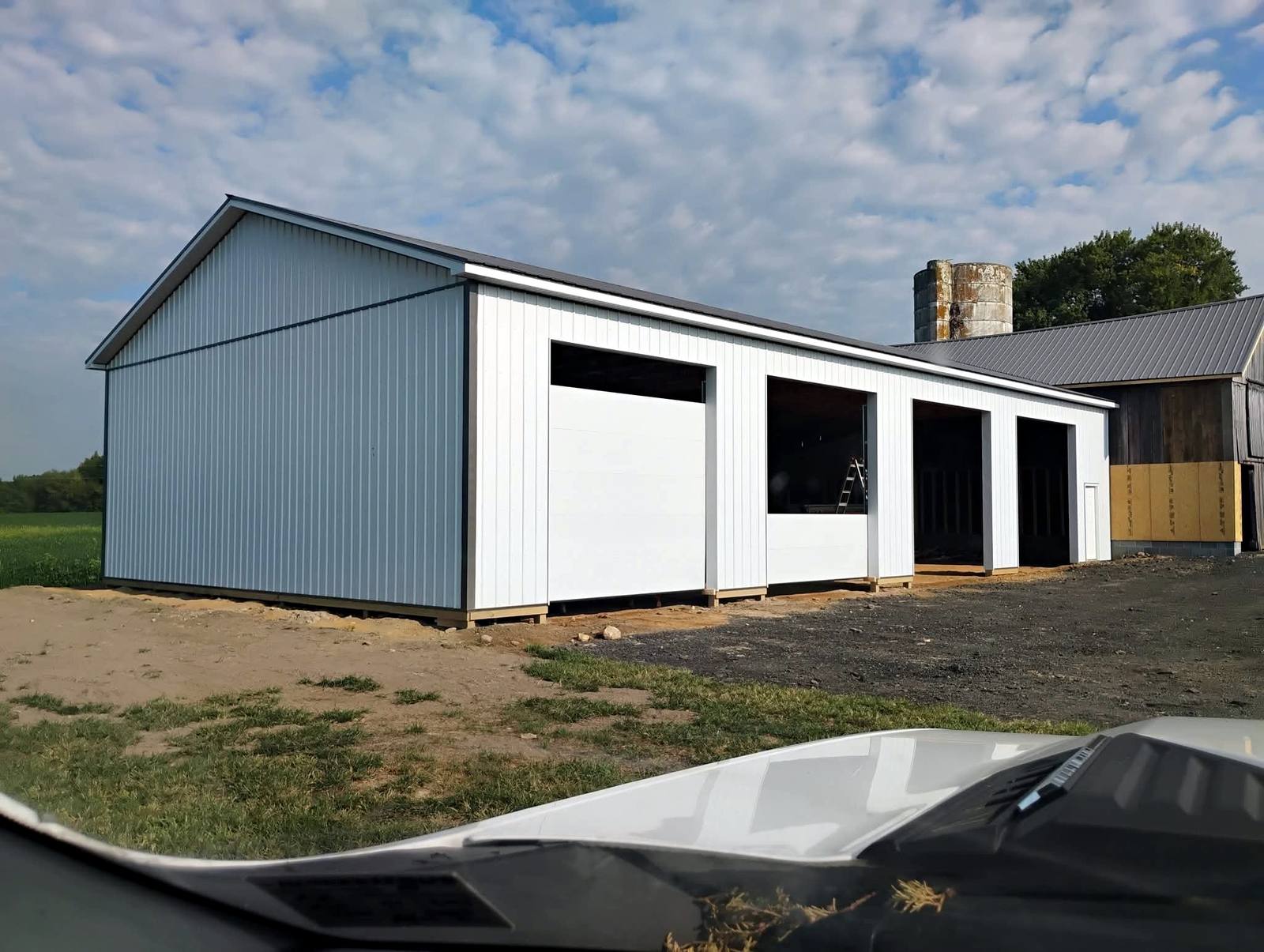Large blue metal outbuilding with white trim