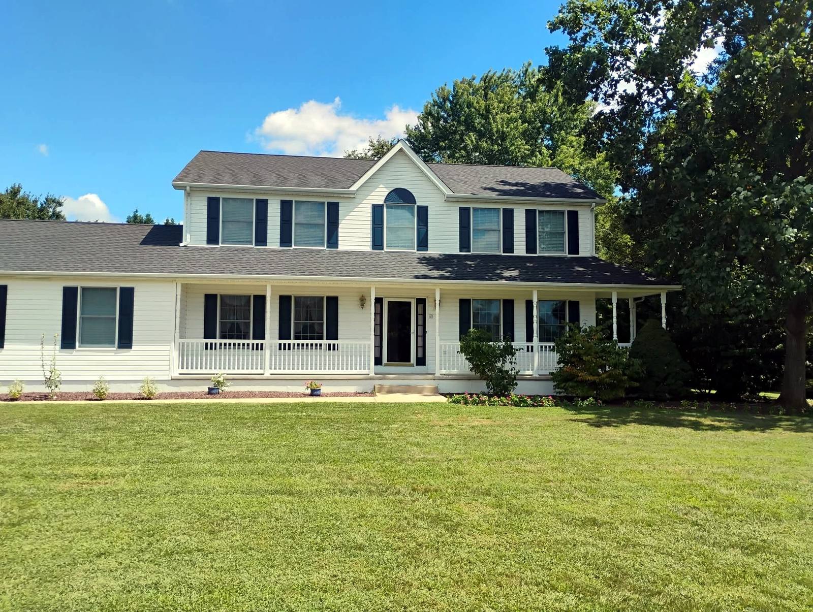 Finished screened porch overlooking a broad lawn