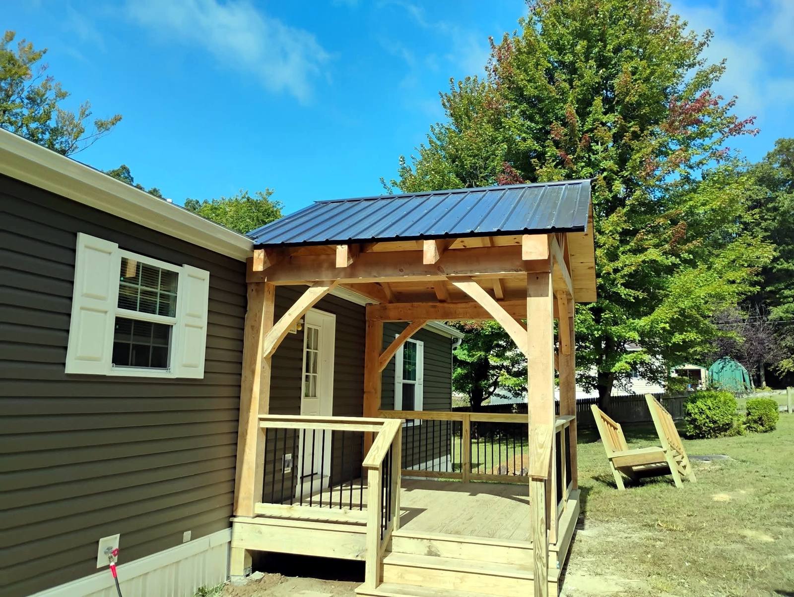Timber-frame covered porch on a brown home