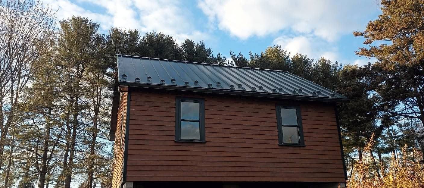 Completed brown outbuilding in a winter landscape