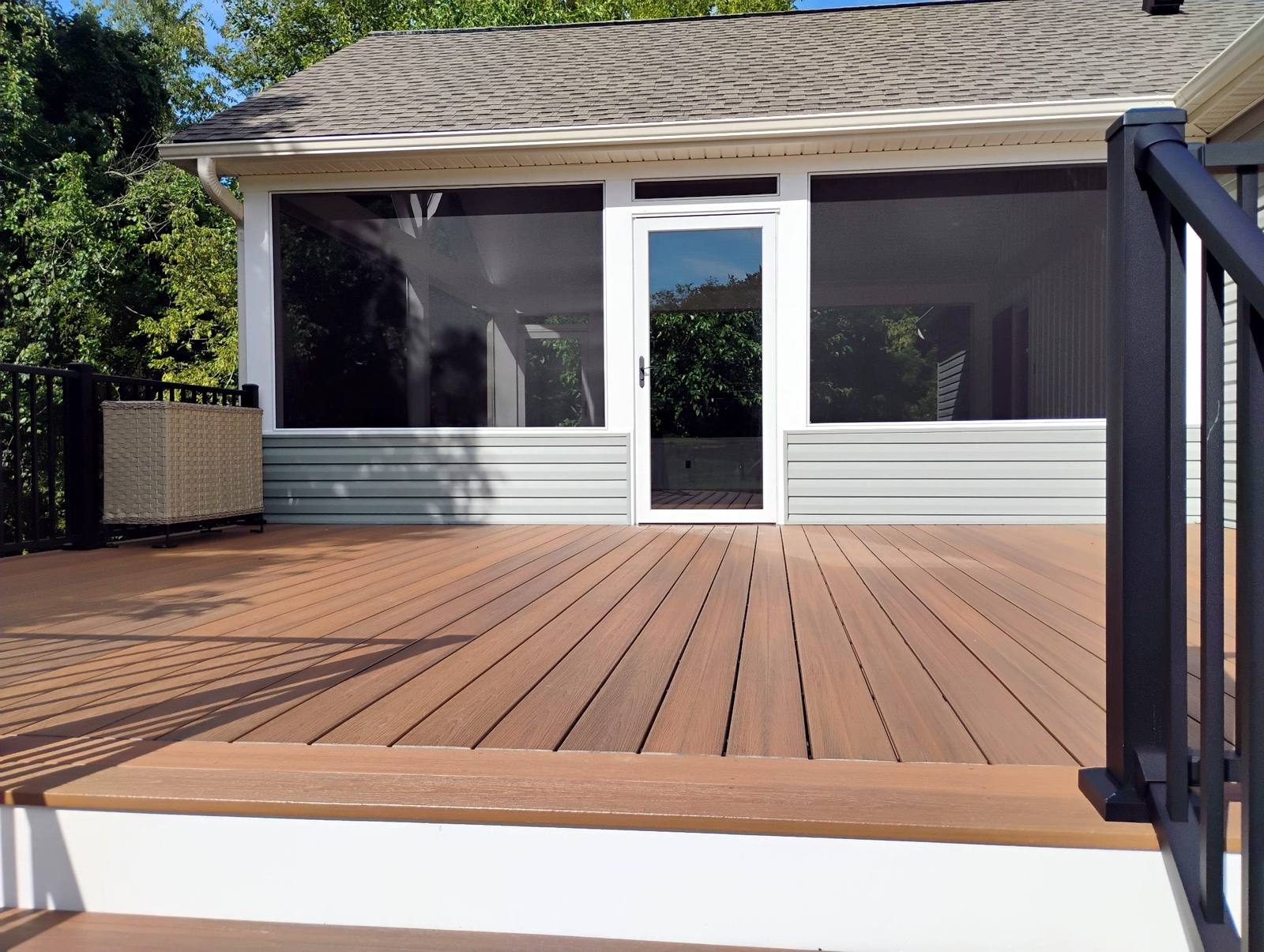 Completed covered outdoor structure beside a home