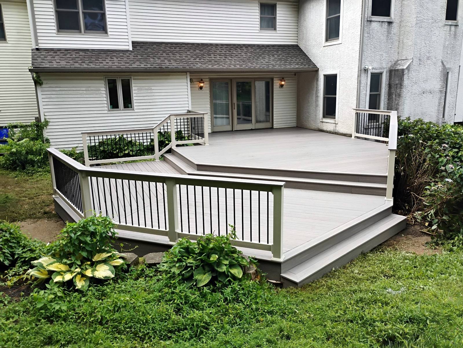 Finished platform deck beside a white home