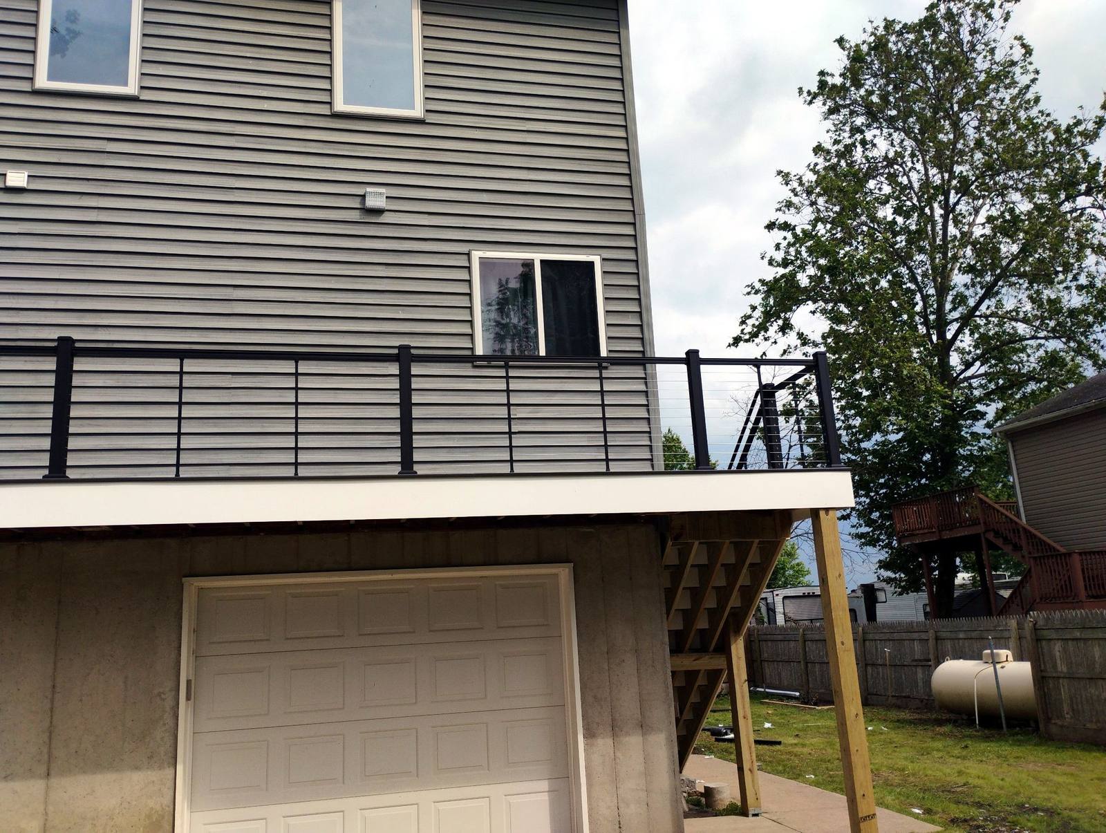 Finished covered deck across the rear of a two-story home
