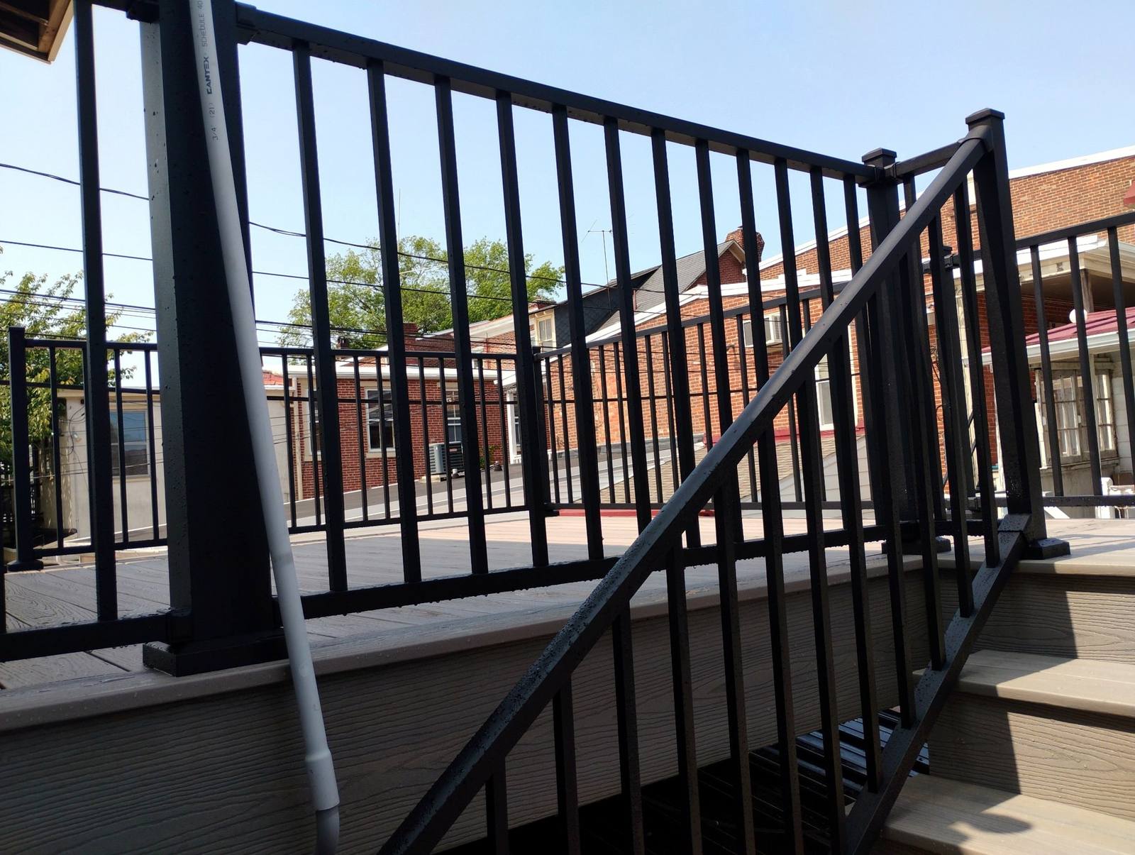 Completed deck steps with black metal balusters