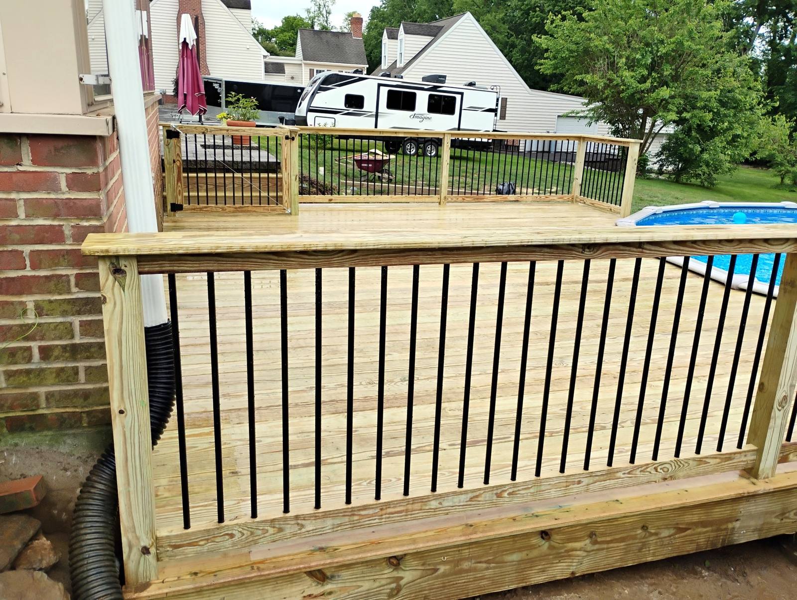Wood safety gate on a completed pool deck