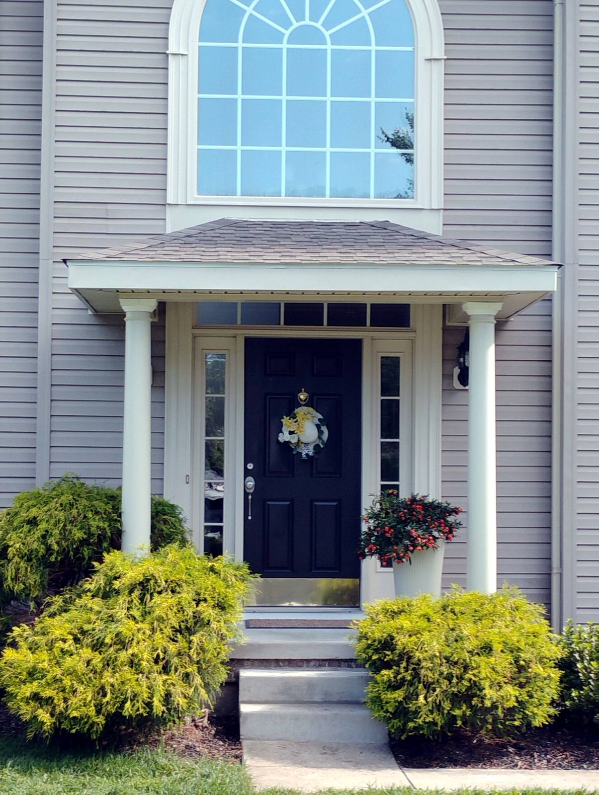 Finished front entry with stone facade and dark blue door