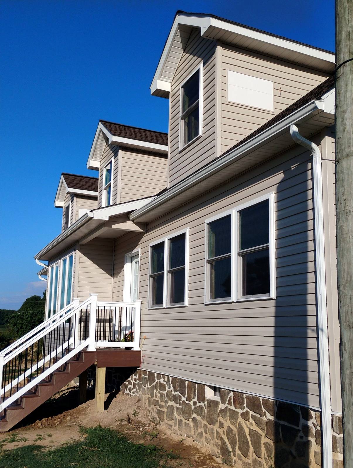 Covered side porch on a completed white home