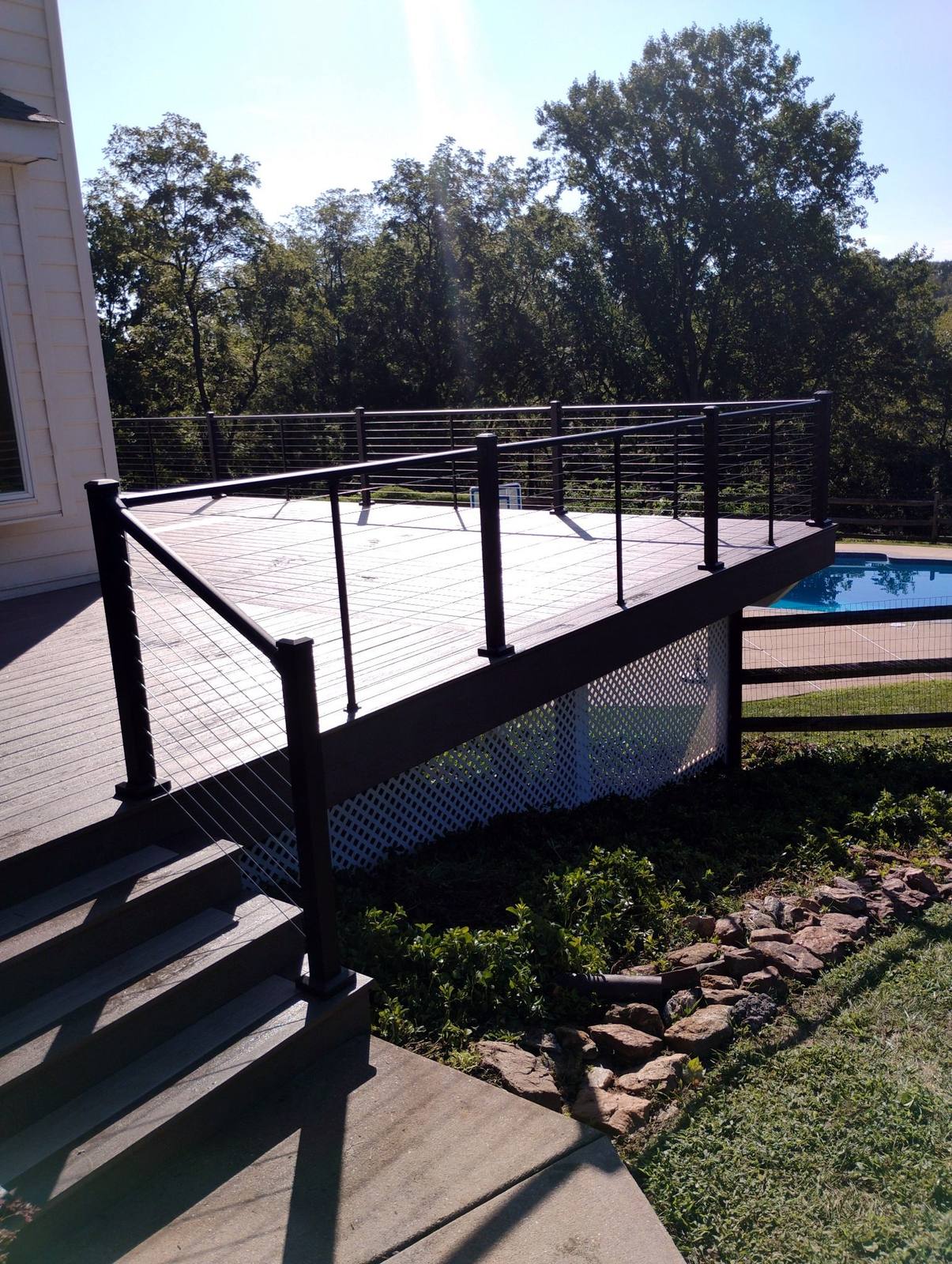 Black metal railing and stairs on a completed deck