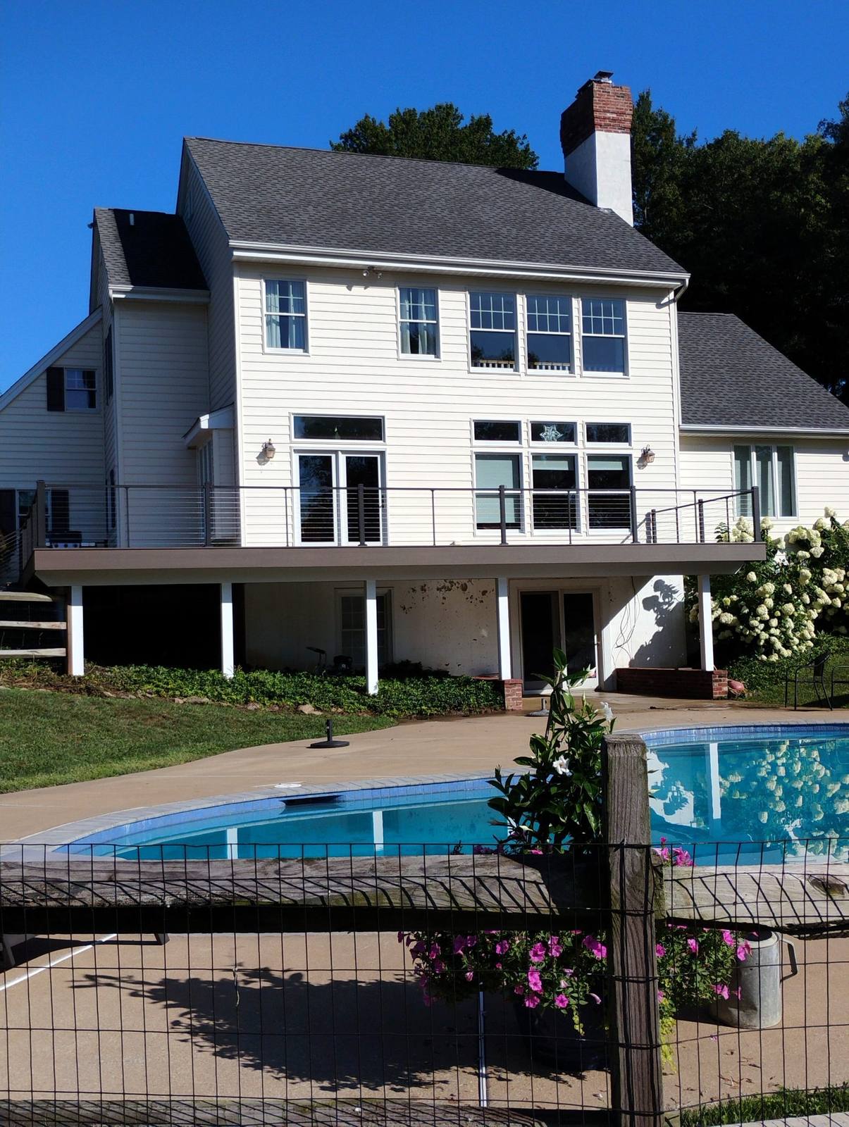 Finished raised deck beside a backyard pool
