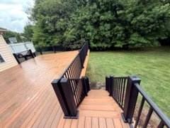 Wide finished deck floor with black railings