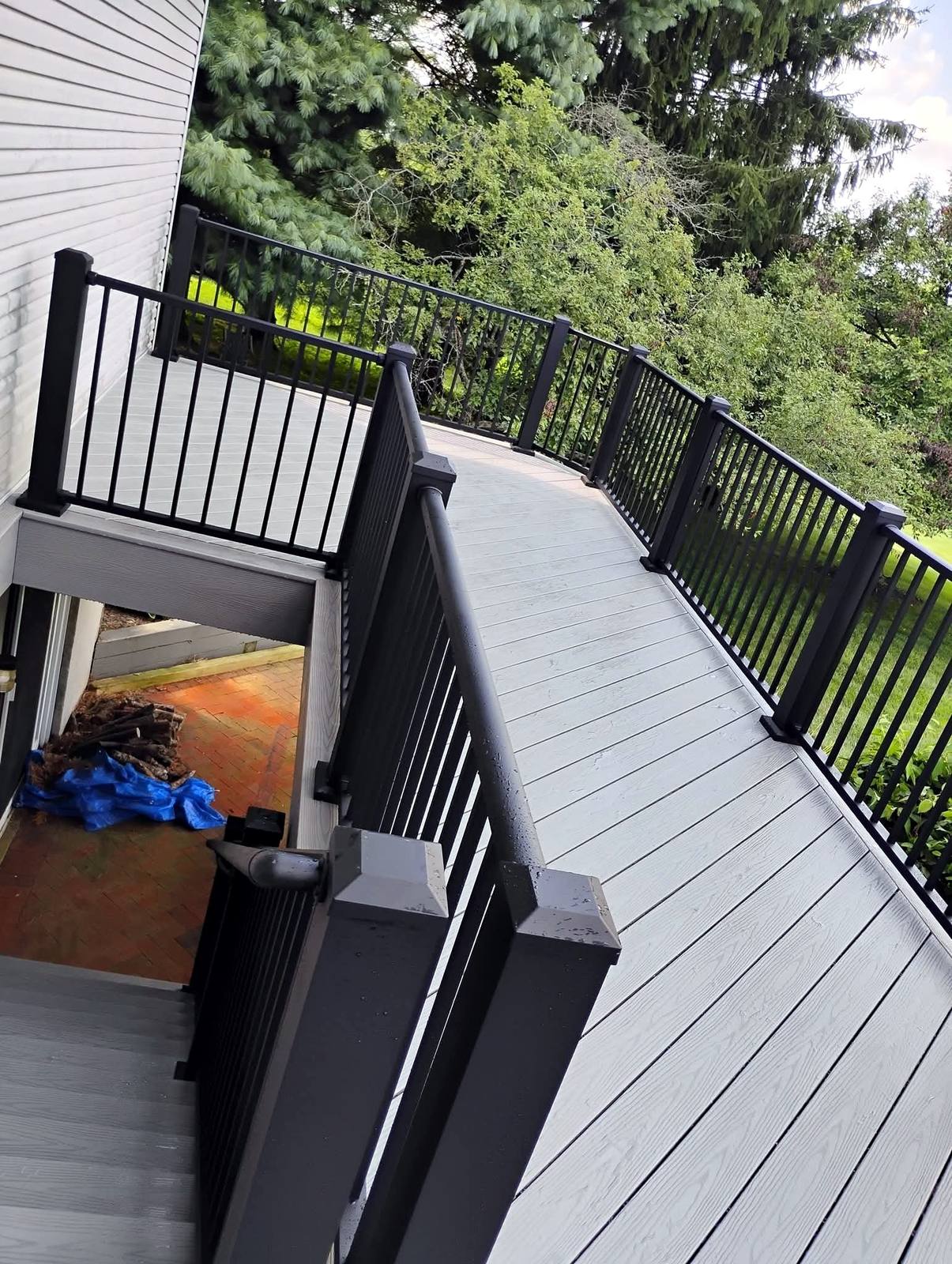 Elevated gray deck with black metal railing